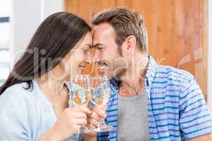 Young couple toasting wine glasses