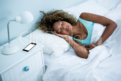 Young woman sleeping on bed Young woman sleeping on bed