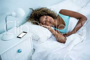 Young woman sleeping on bed