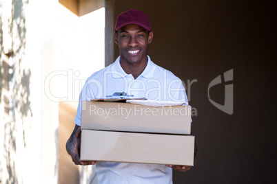 Happy delivery man holding a parcel