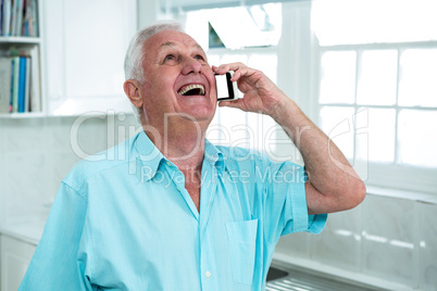 Happy senior man talking on phone