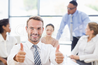 Portrait of businessman showing her thumbs up