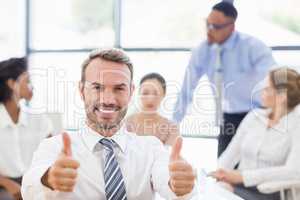 Portrait of businessman showing her thumbs up