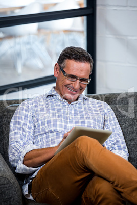 Happy man using digital tablet