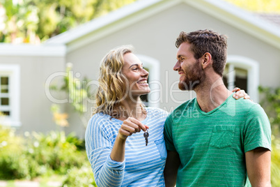 Couple looking each other while holding keys