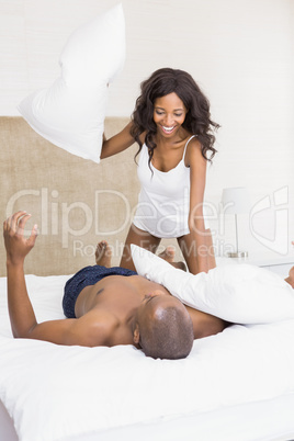 Young couple having a pillow fight