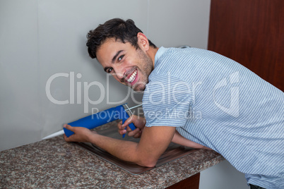 Portrait of smiling man using pest control injection