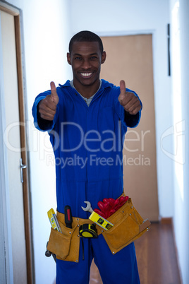 Happy handy man showing his thumbs up