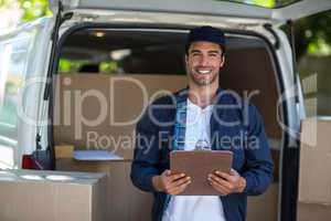 Portrait of smart delivery man holding clipboard