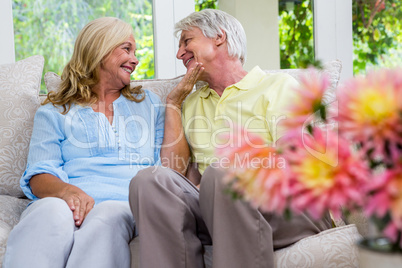 Romantic senior couple sitting in living room