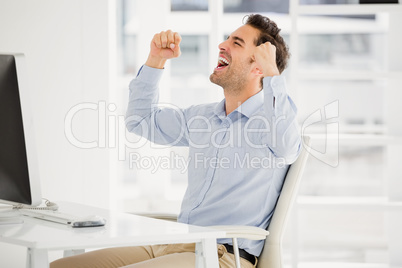 Businessman using laptop and taking notes