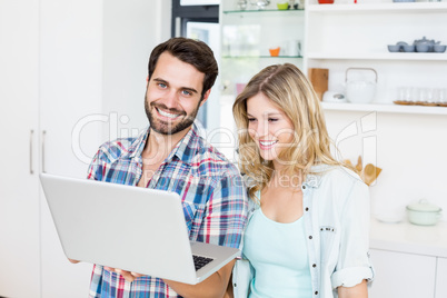 Young couple using laptop