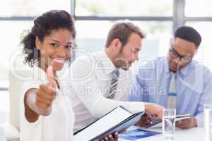 Portrait of businesswoman showing her thumbs up