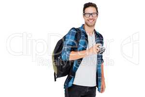 Young man carrying rucksack and holding camera