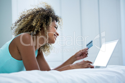 Young woman doing online shopping on laptop