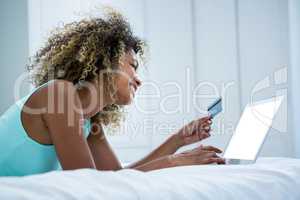 Young woman doing online shopping on laptop