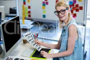 Graphic designer sitting at her desk in the office