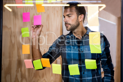 Man writing on sticky notes