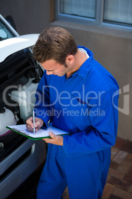 Mechanic preparing a check list