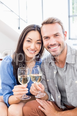 Young couple toasting wine glasses