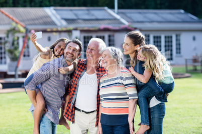 Multi-generation family taking a selfie in garden