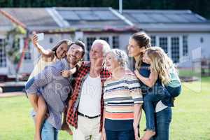 Multi-generation family taking a selfie in garden