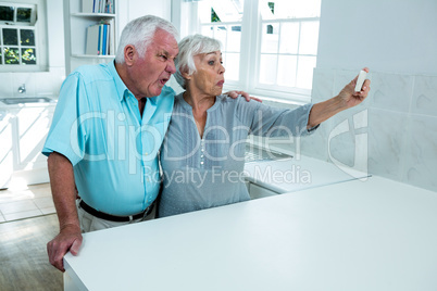 Playful retired couple taking selfie