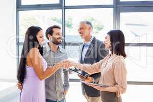 Couple shaking hand with real estate agent