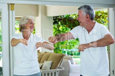 Senior couple exercising at home