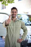 Portrait of smiling pesticide worker showing thumbs up