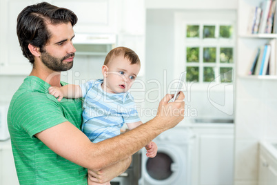 Father taking selfie with cute baby boy