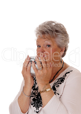Senior woman drinking her sup.