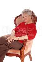Relaxed senior woman sitting in armchair.