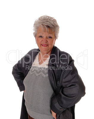 Senior woman standing in a coat.