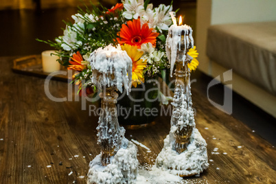 Photo of old candles and flowers .