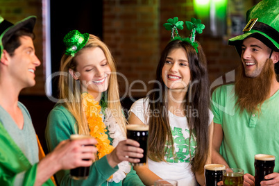 Smiling friends with Irish accessory