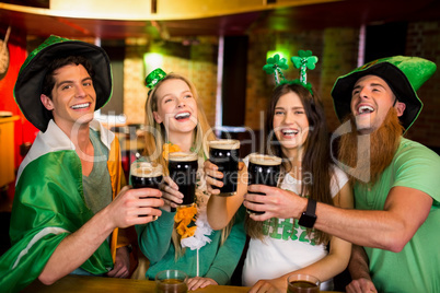 Smiling friends with Irish accessory