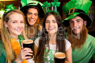 Smiling friends with Irish accessory
