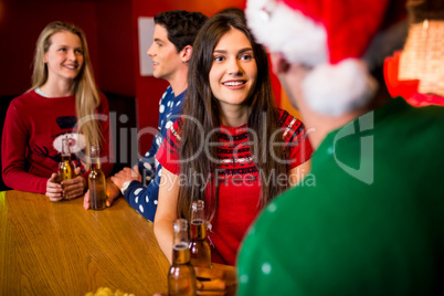 Smiling friends with christmas accessory