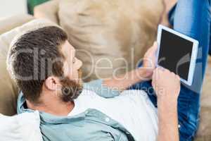 Man using a digital tablet in living room