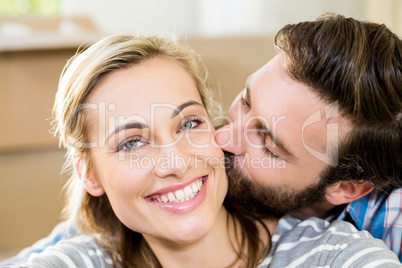 Young man kissing on womans cheek