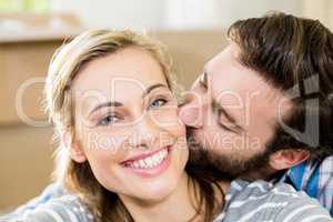 Young man kissing on womans cheek