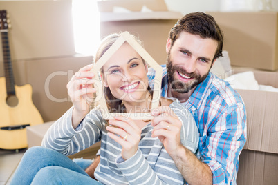 Portrait of couple holding popsicle in living room