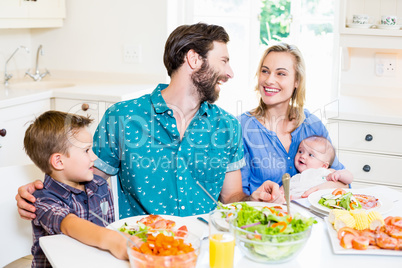 Family having meal in kitchen