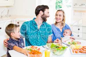 Family having meal in kitchen
