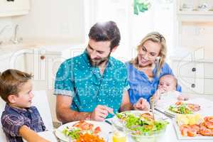 Family having meal in kitchen