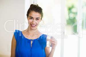 Young woman holding glass of a water