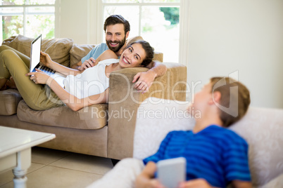 Parents talking to a son while using laptop