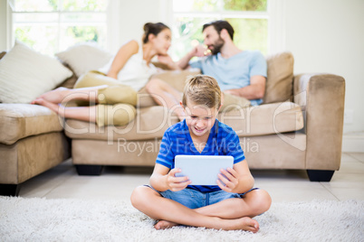 Boy using a digital tablet in living room