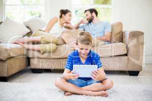 Boy using a digital tablet in living room